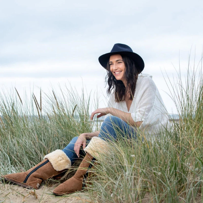Women sitting on beach wearing Australian Made Women's Ugg Boots