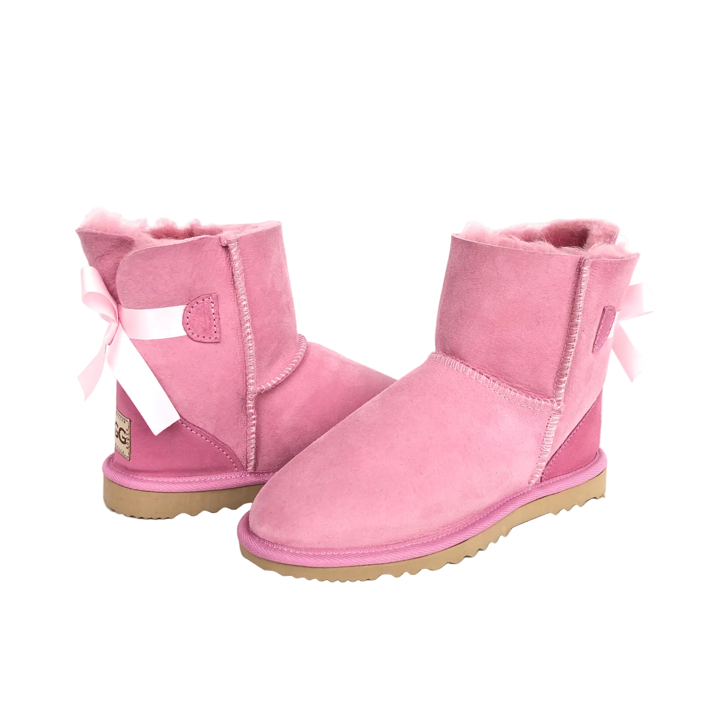 Australian Made pair of women's pink sheepskin ugg boots with bows on a white background
