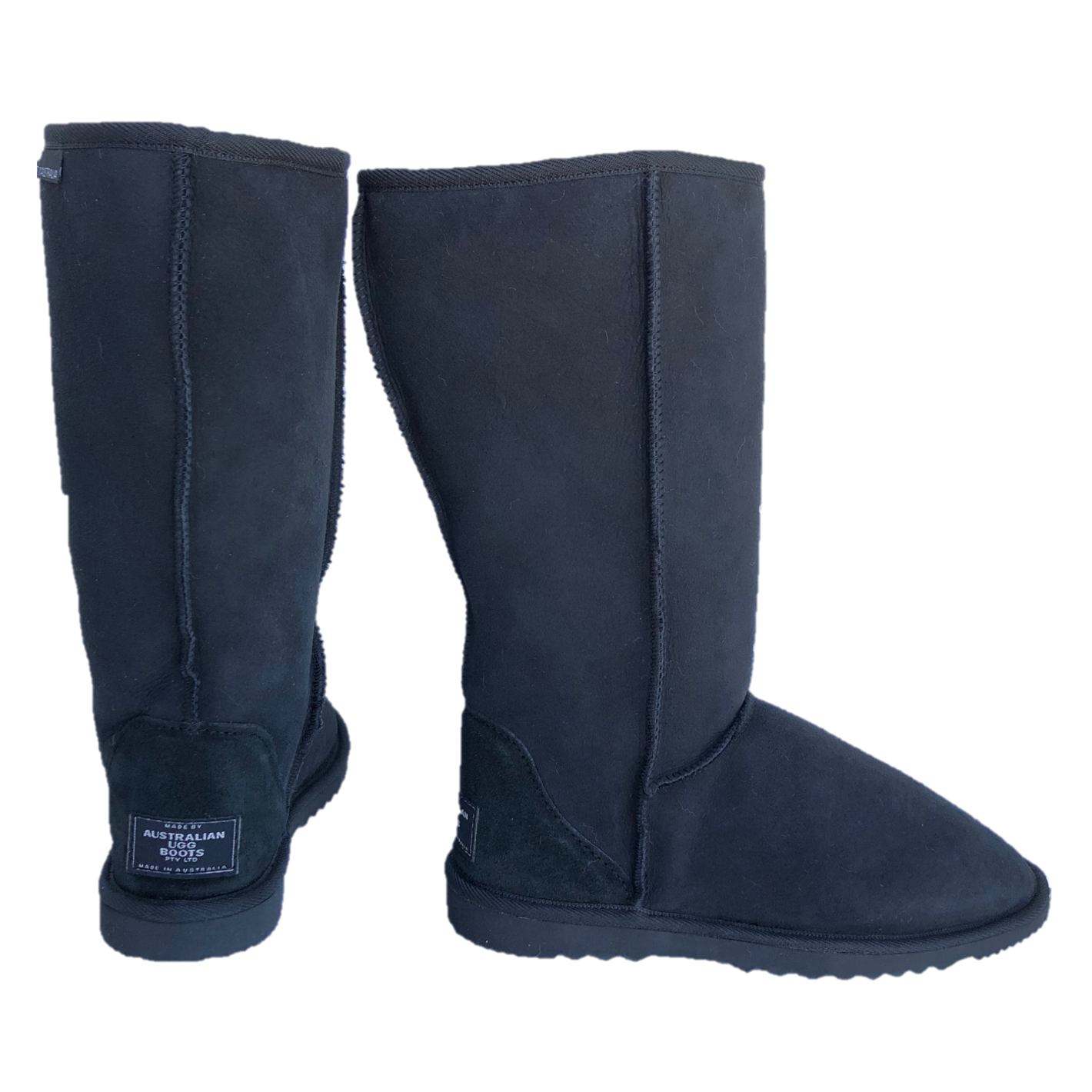 Black tall ugg boots, one boot with sheepskin folded down