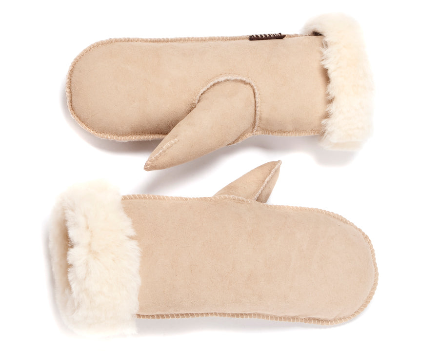 A pair of beige sheepskin mittens with faux fur lining.