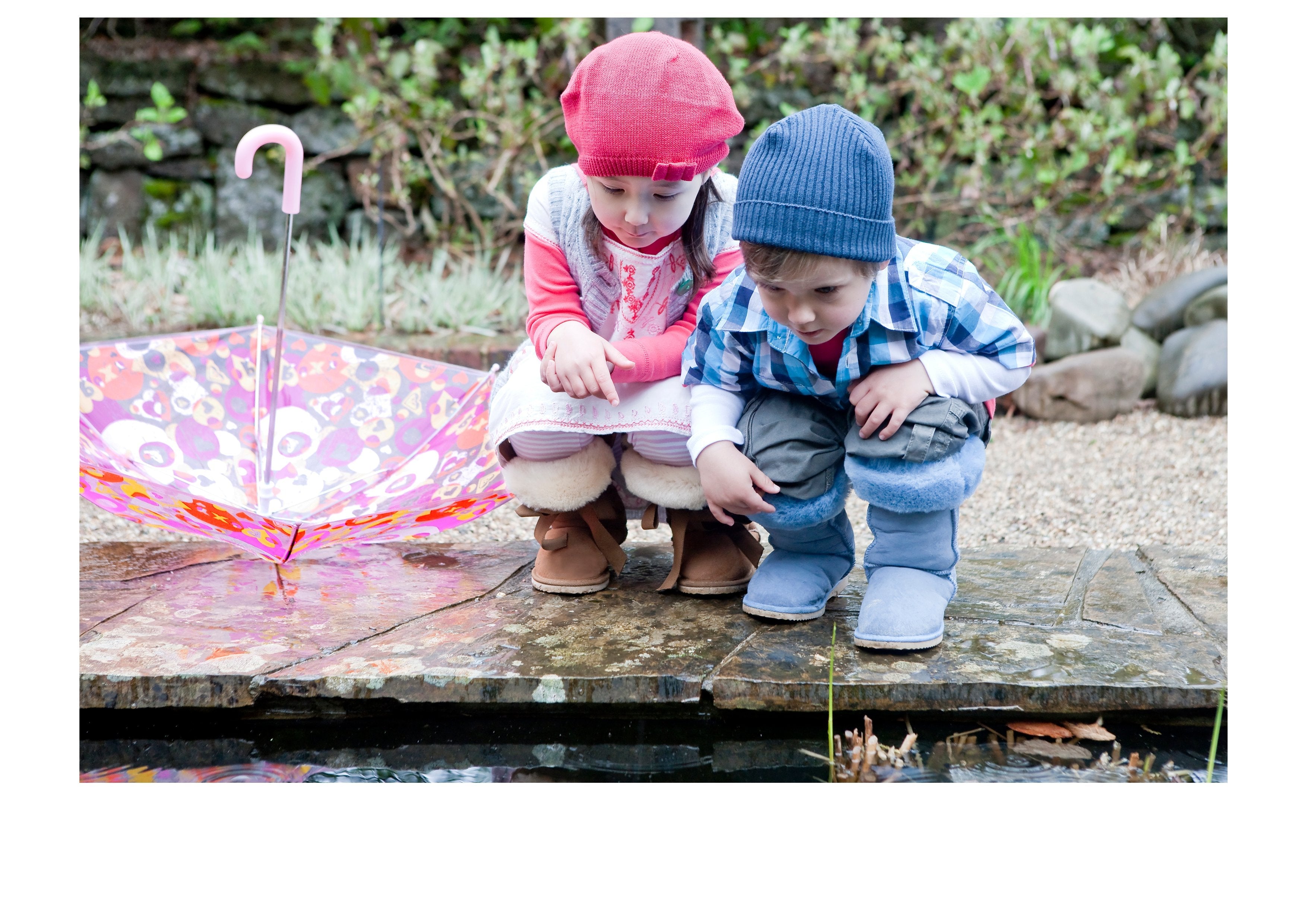 Two children wearing Ugg Boots outside