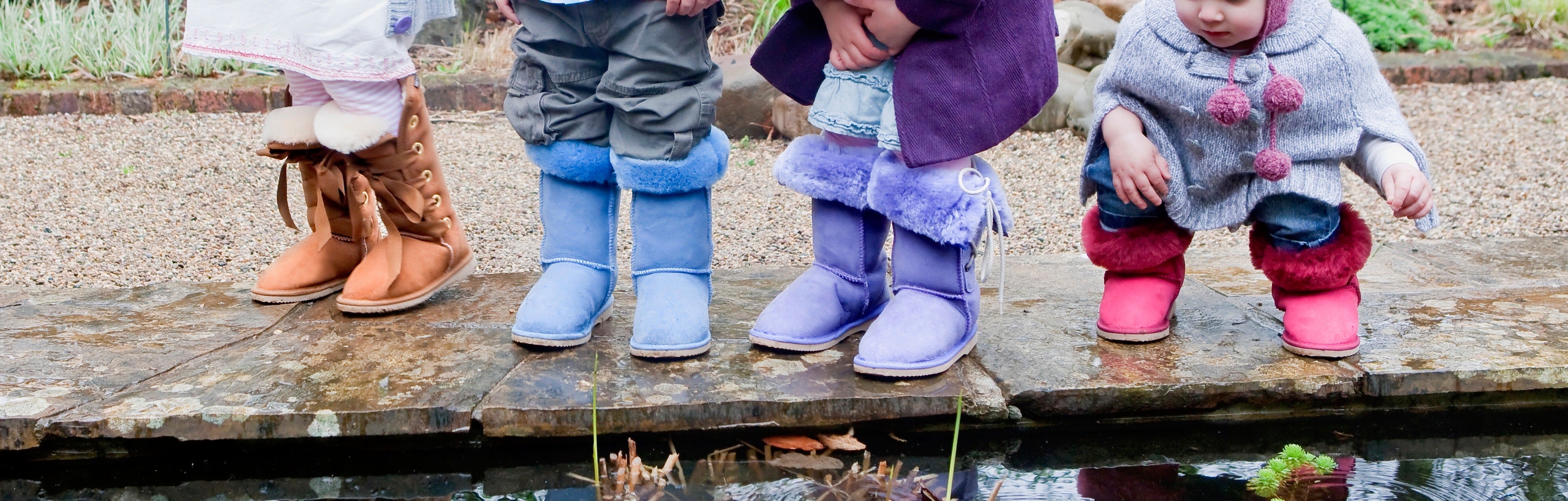 Two children wearing Ugg Boots outside