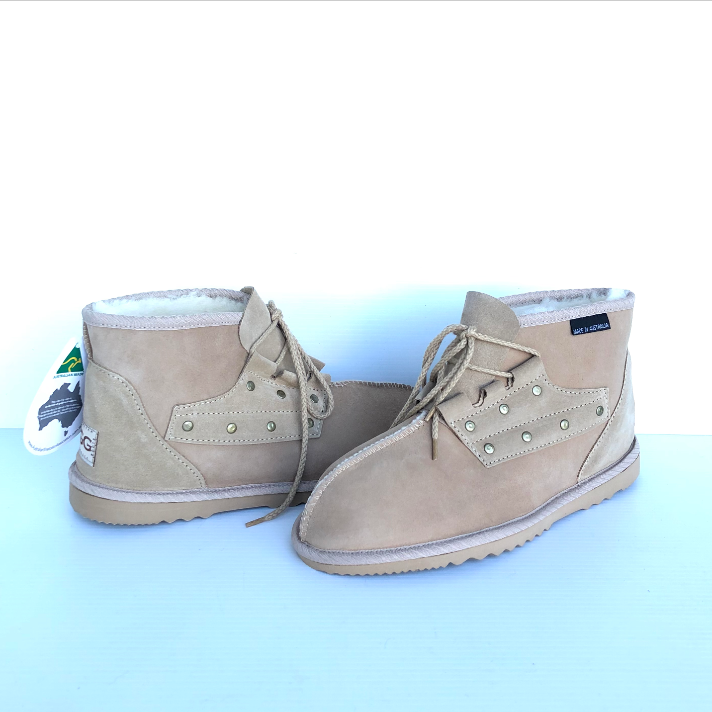 Pair of sand coloured chestnut desert boots with laces